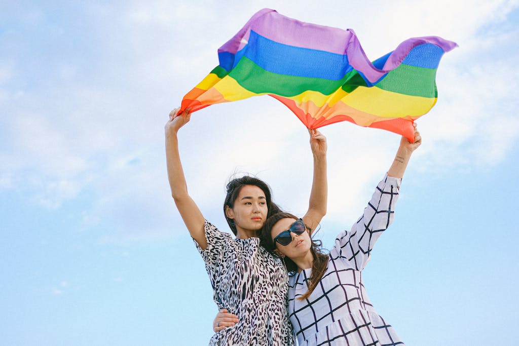 A Couple Waving a Rainbow Flag Gay travel Outside the US