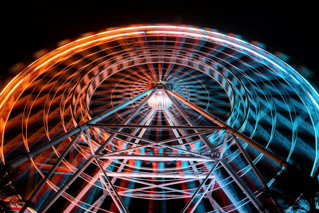 A ferris wheel in the dark with colorful lights - Gay events in orlando