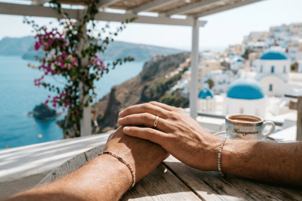 Two men holding hands on their gay honeymoon vacation.